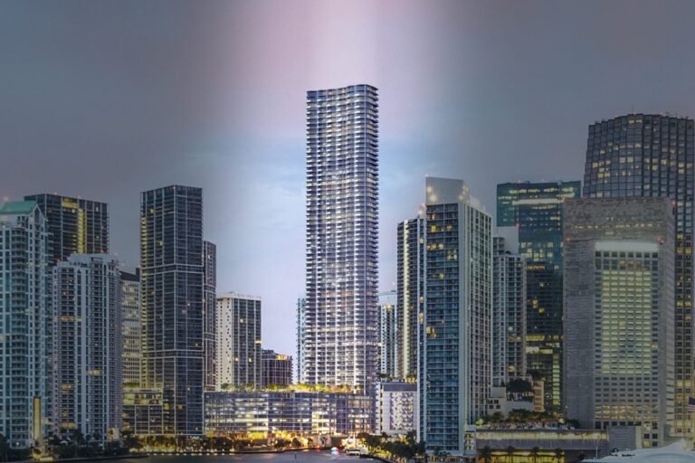 Developer rendering of Baccarat Residences Miami, the 75-storey tower on the Miami River in Brickell, shown at dusk above the surrounding skyline