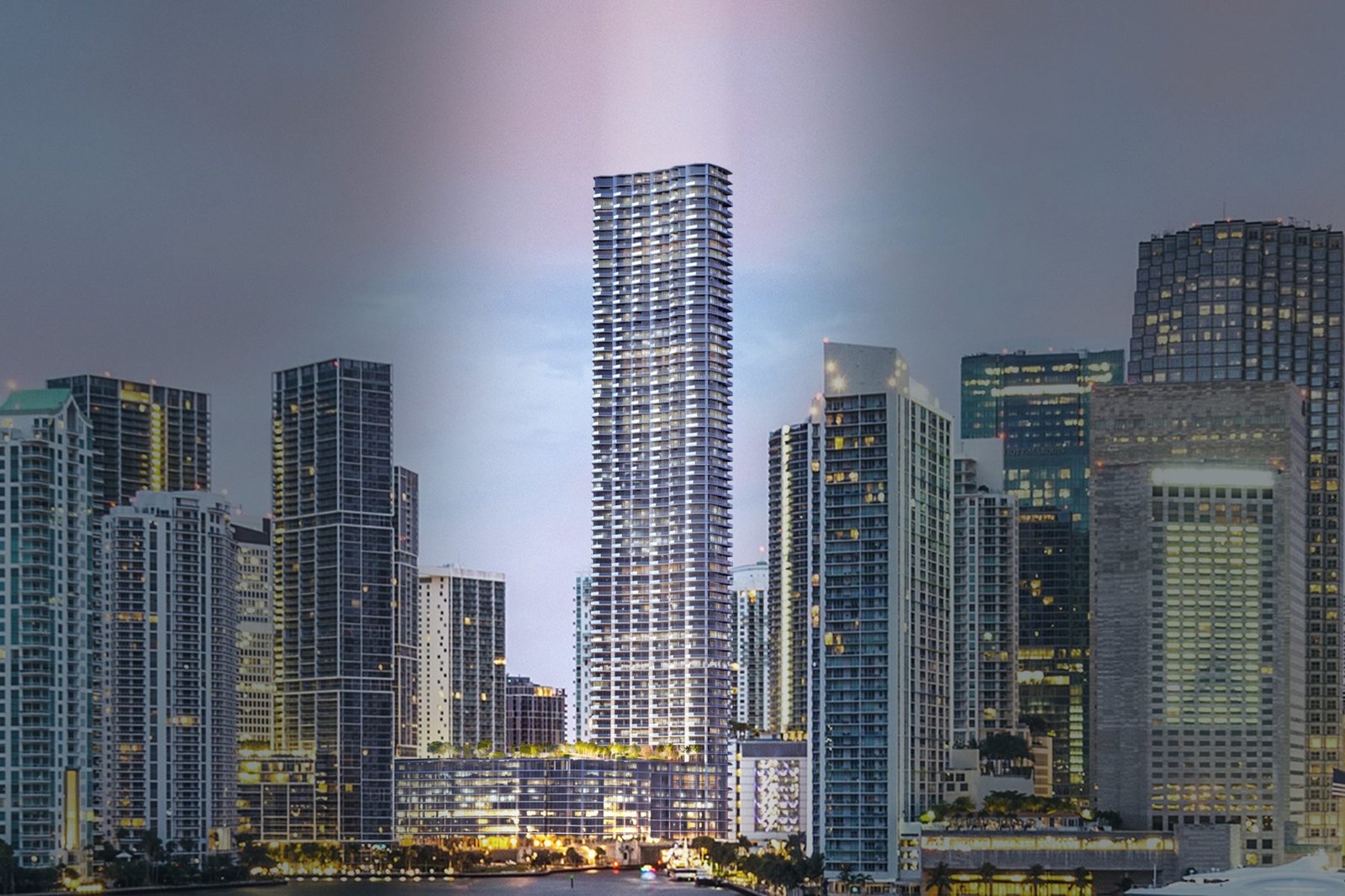 Developer rendering of Baccarat Residences Miami, the 75-storey tower on the Miami River in Brickell, shown at dusk above the surrounding skyline