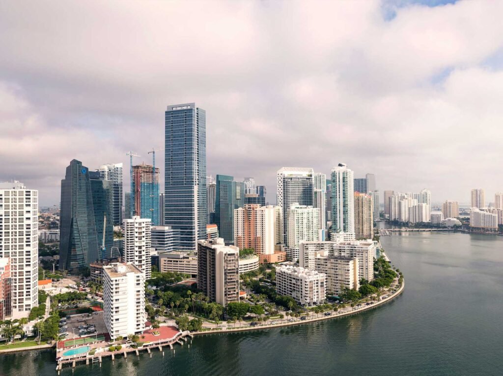 - Brickell Condos Aerial of Brickell Key and the Brickell peninsula with construction cranes among the towers