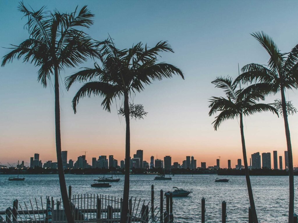 - The Lofts on Brickell Palms silhouetted against the Miami skyline at sunset