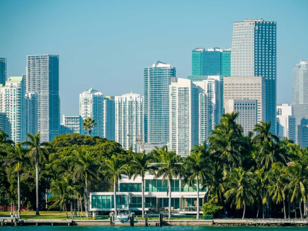 - Solaris at Brickell Brickell skyline behind palms and a modern waterfront residence