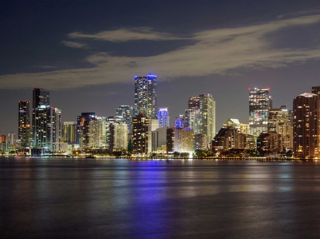 Brickell skyline at night reflected across Biscayne Bay