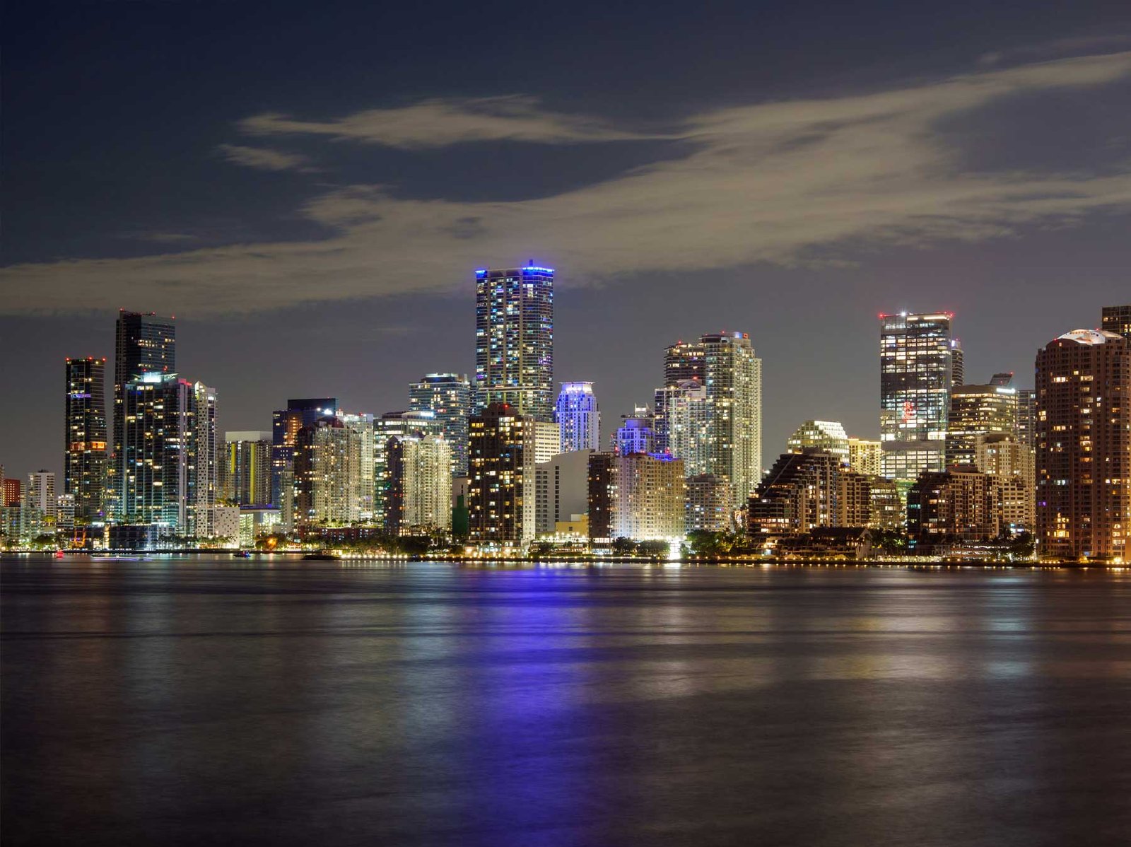 Brickell skyline at night reflected across Biscayne Bay