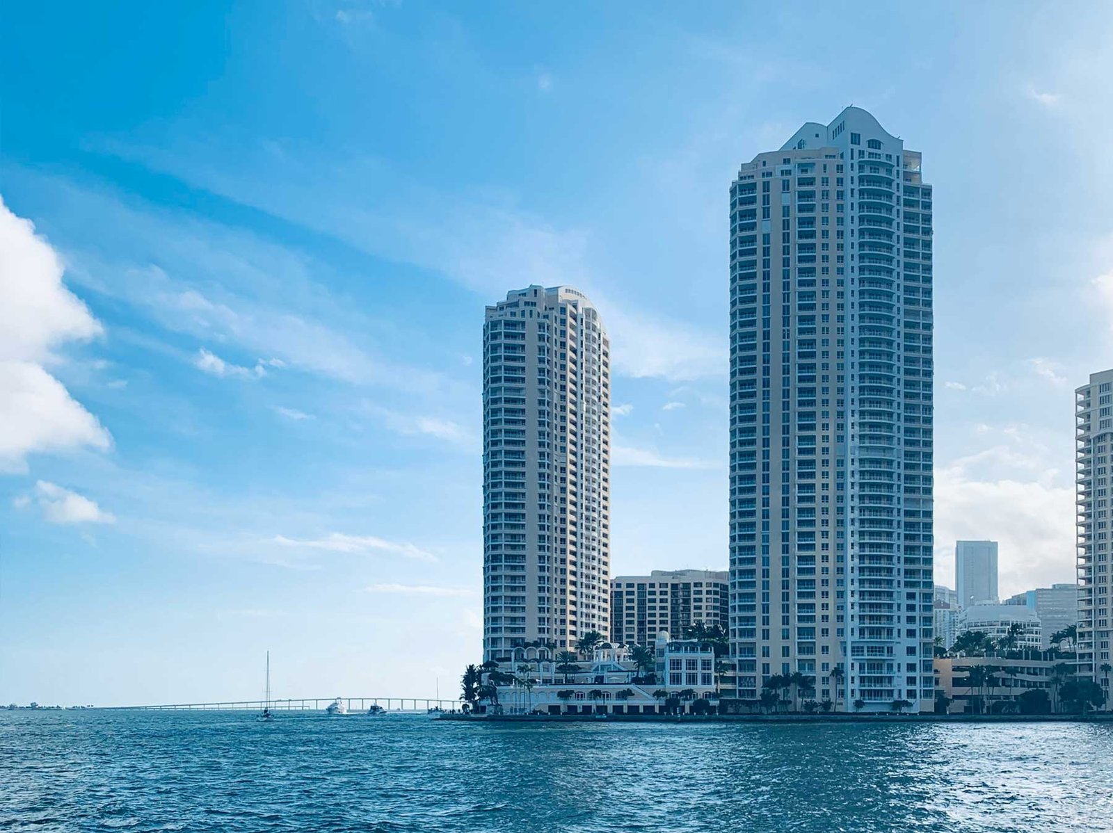 Twin waterfront condominium towers rising above the bay