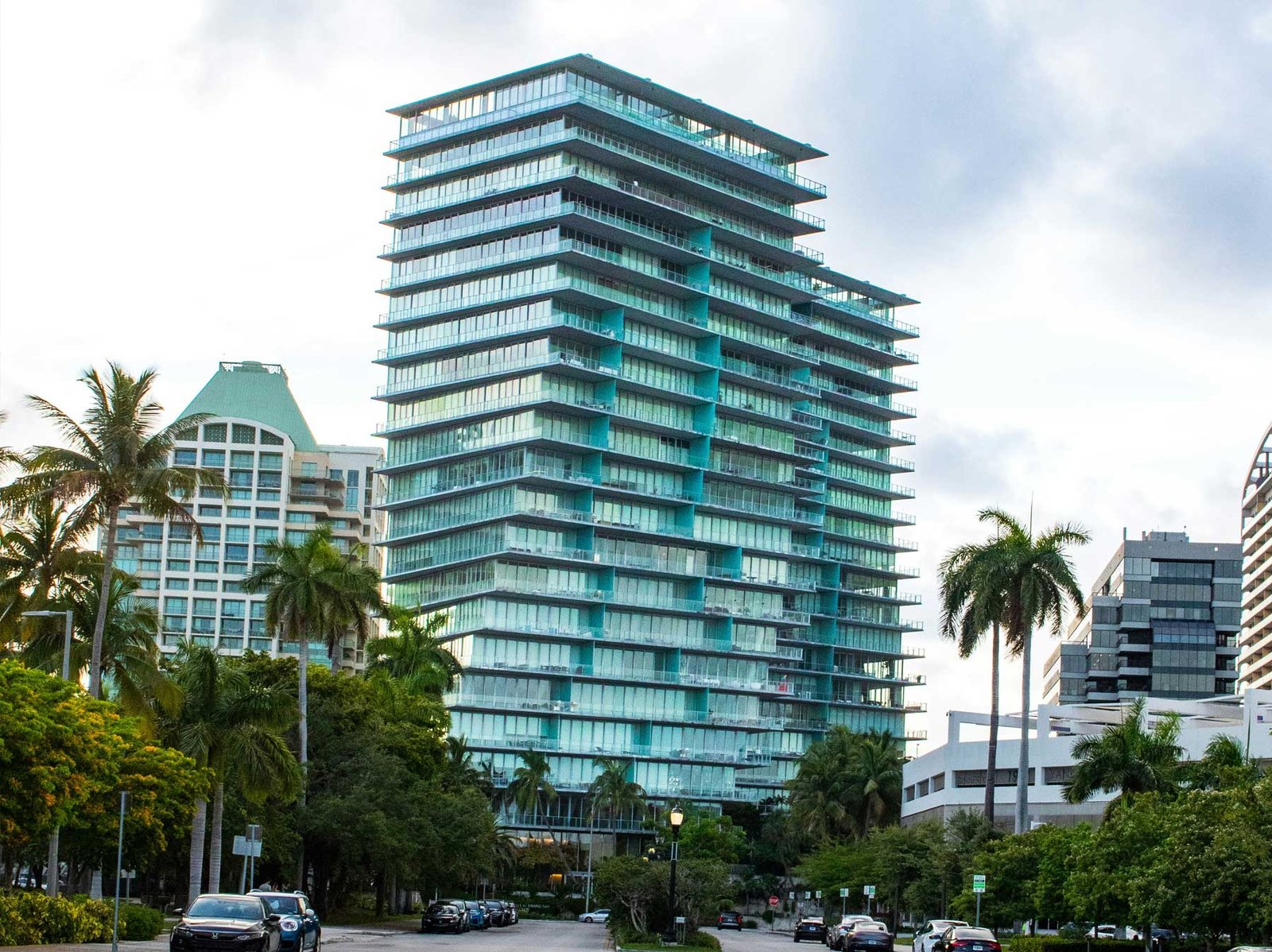 Modern glass residential tower in Coconut Grove seen from the street
