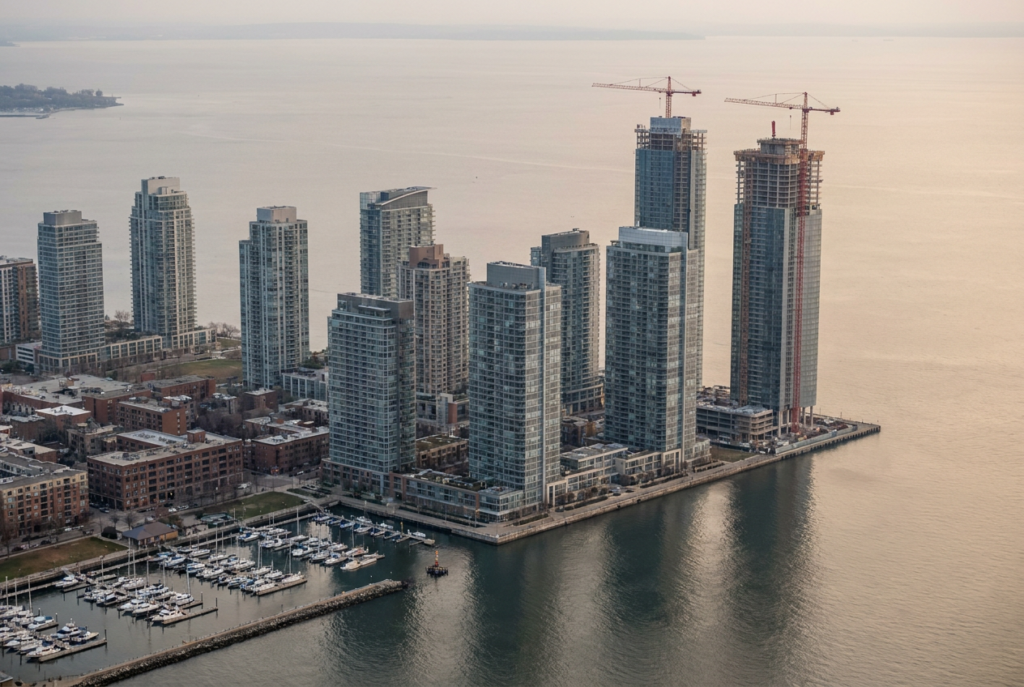 Aerial view of the Edgewater bayfront — a row of residential towers with two under construction