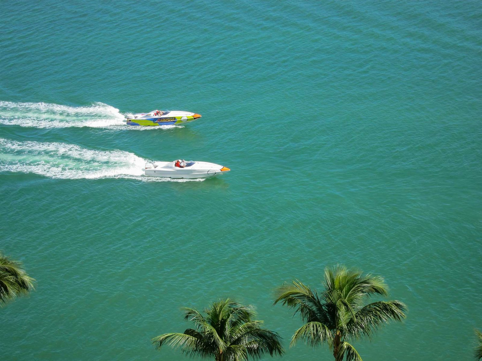 - Sell Your Miami Property A speedboat crossing turquoise water off Miami Beach