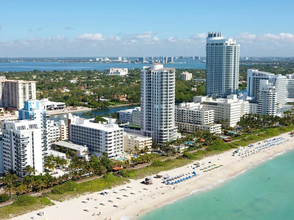 Aerial over Mid-Beach oceanfront towers and the beach