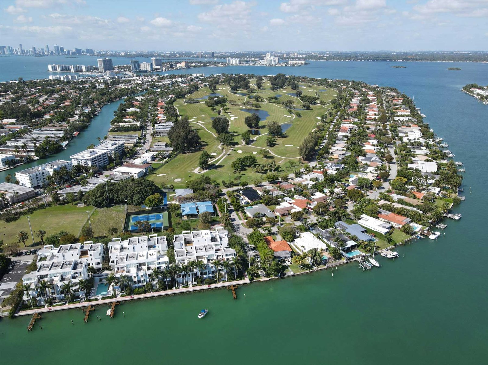 Aerial of a residential Miami island of waterfront homes ringed by private dockage
