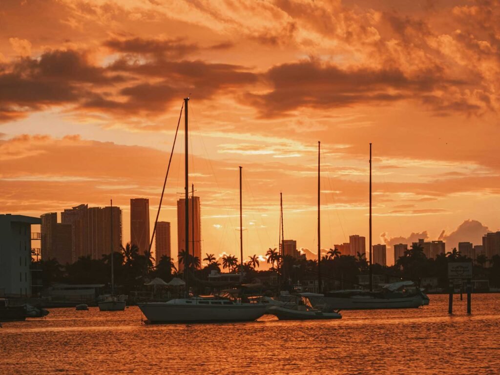 Sailboats moored at sunset with the Miami skyline in the distance