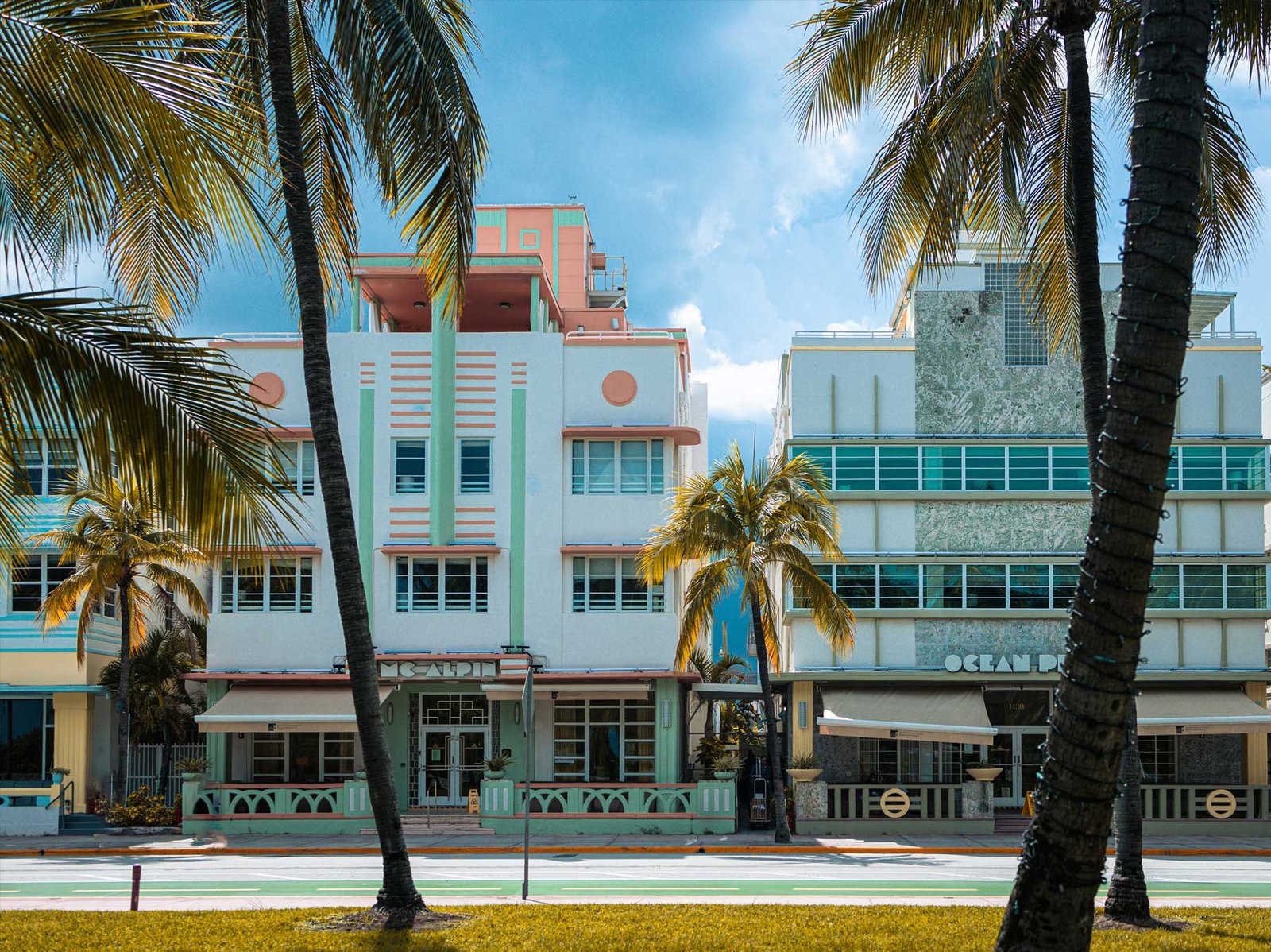 Symmetrical Art Deco hotel frontage framed by palms, South Beach