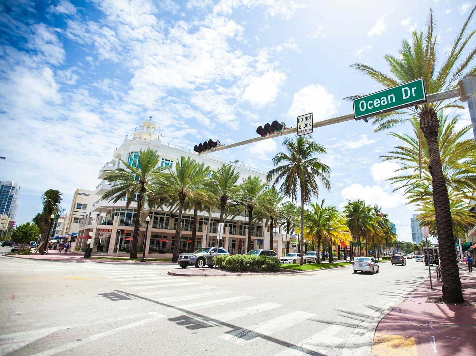 A South Beach street lined with low Art Deco buildings and palm trees