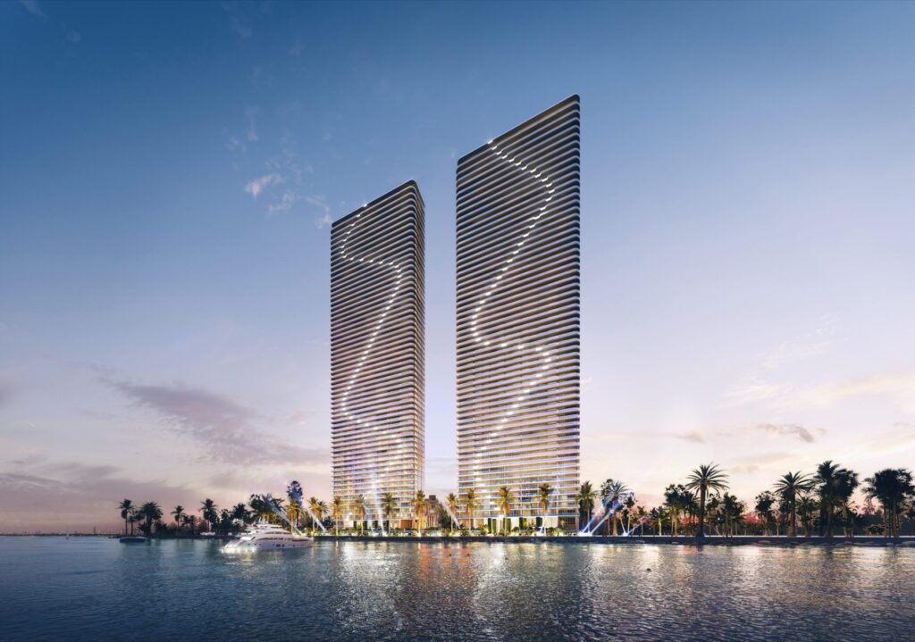 Aria Reserve twin towers, Edgewater Miami — dusk exterior view from Biscayne Bay, developer rendering