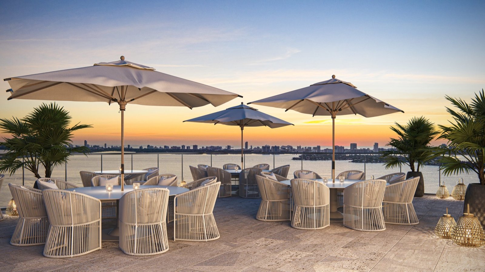 Aria Reserve, Edgewater Miami — terraza de comedor en la azotea al atardecer con vista a través del agua hacia un horizonte urbano lejano, render del desarrollador