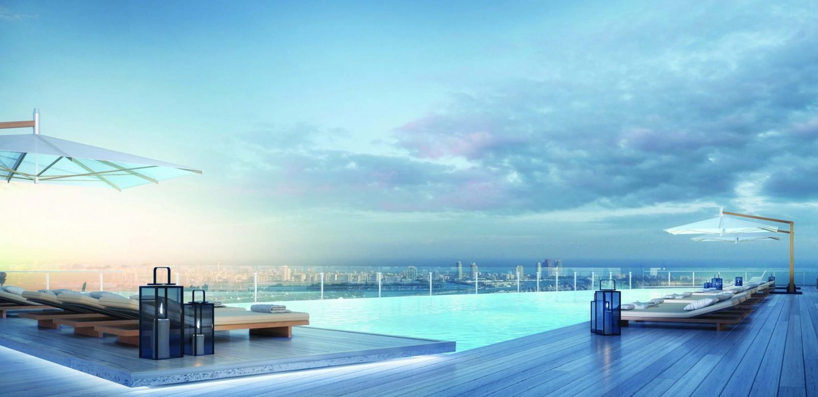The tower at the waterfront at dusk, palms and a moored superyacht — developer rendering