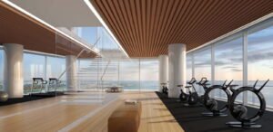 The lobby, timber-lined walls and full-height glass — developer rendering