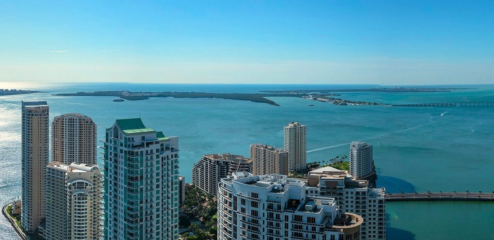 Aerial over Brickell Key and Biscayne Bay toward Virginia Key and the causeway, Miami