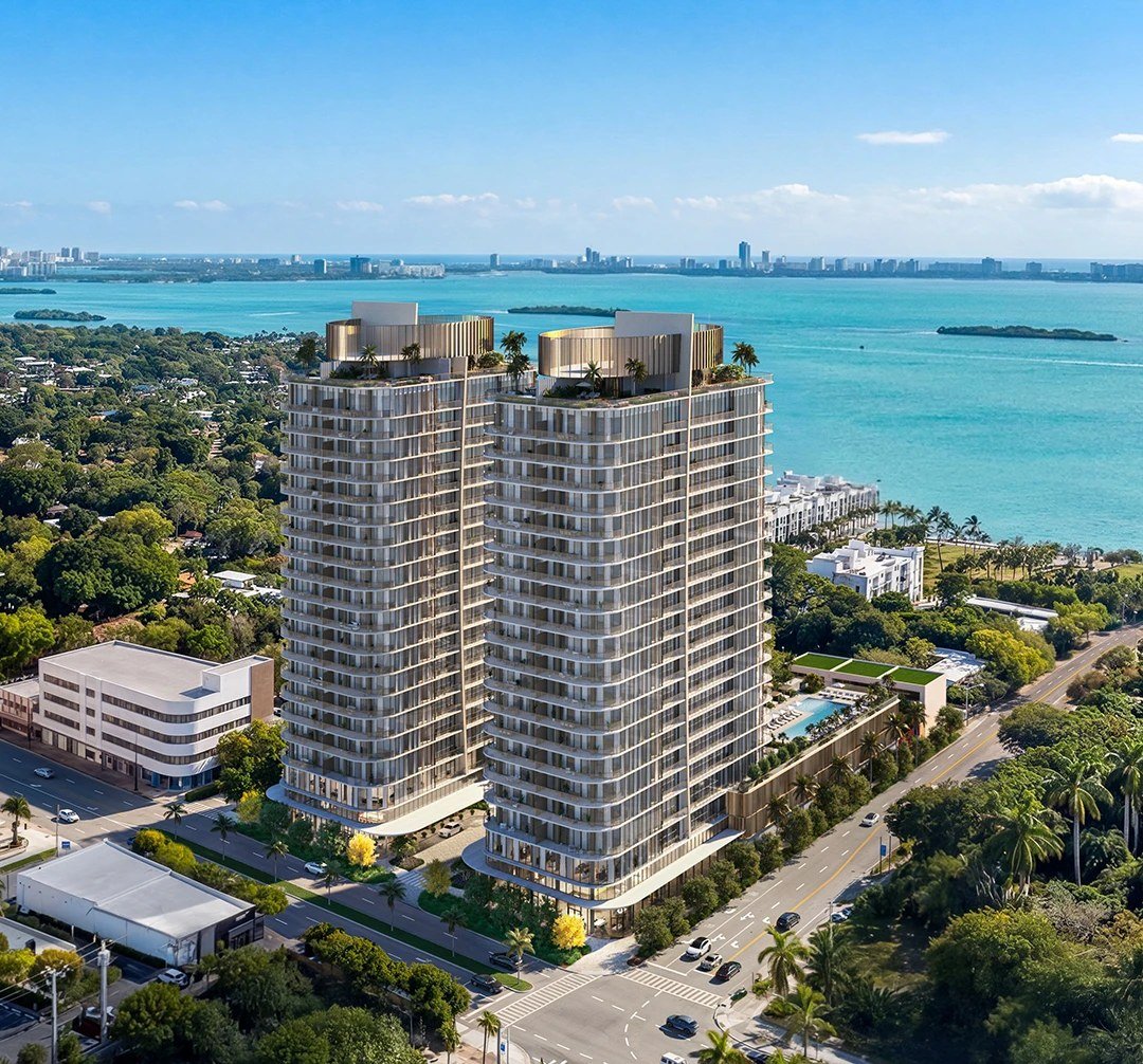 Aerial rendering of the Kempinski Residences Miami Design District twin towers on their Biscayne Boulevard block, with Biscayne Bay behind