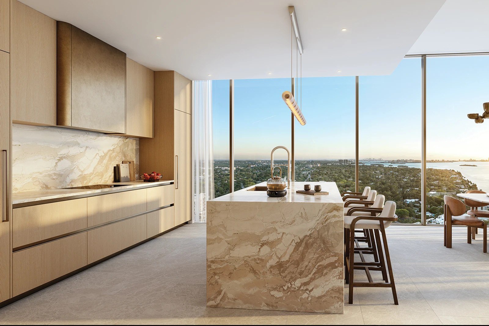 A kitchen at Kempinski Residences Miami Design District with Biscayne Bay beyond, developer rendering