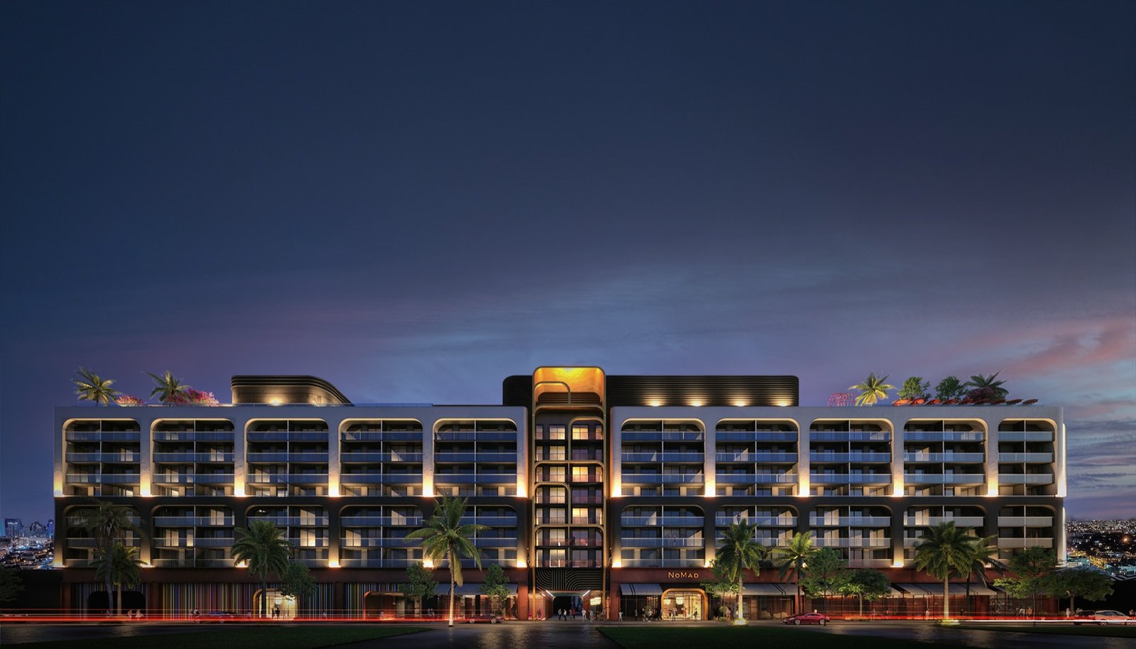 NoMad Residences Wynwood — building elevation at dusk with the NoMad sign lit, developer rendering