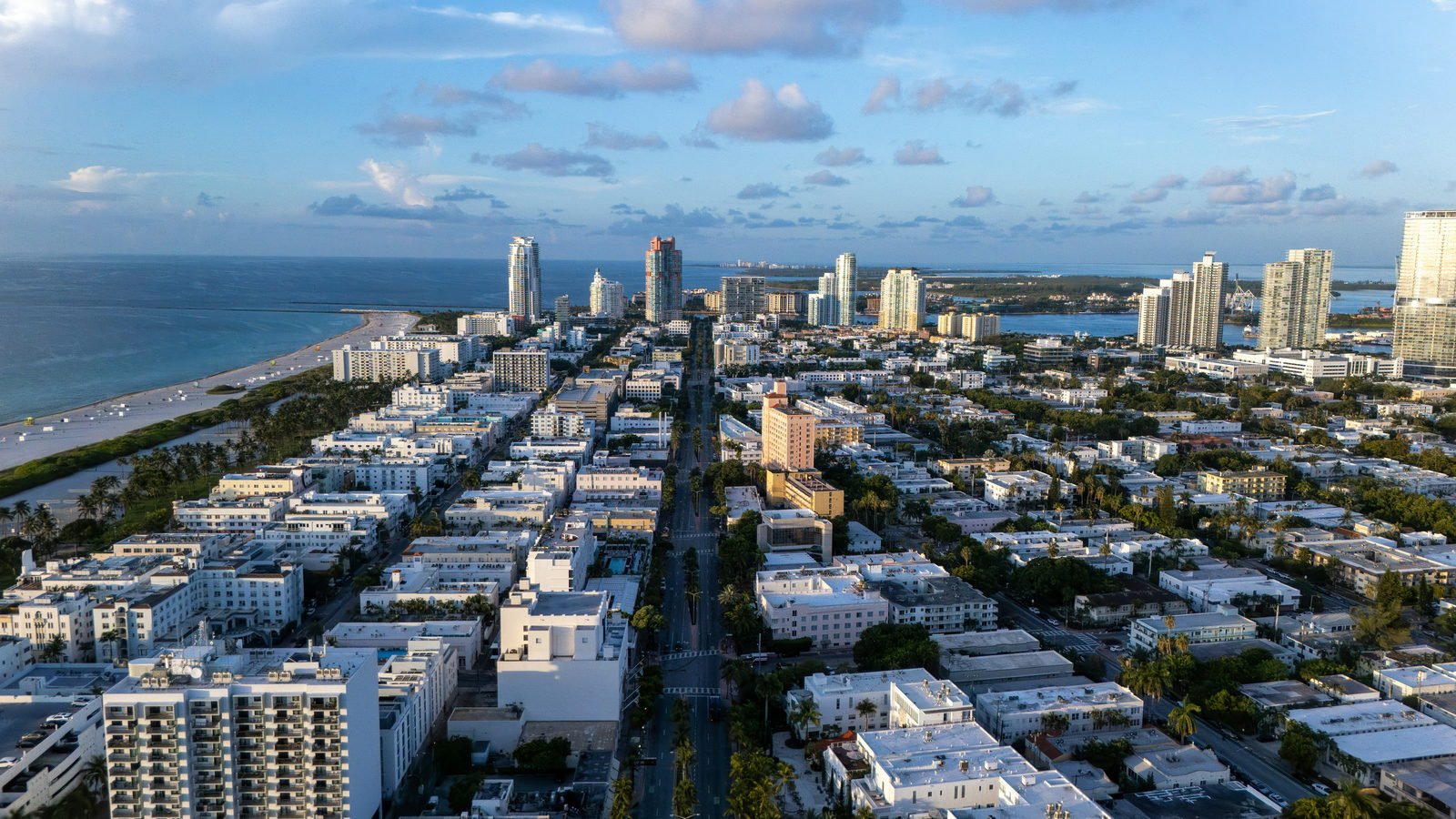 Aerial view of South Beach — the beach, the dune line and the low Art Deco street grid