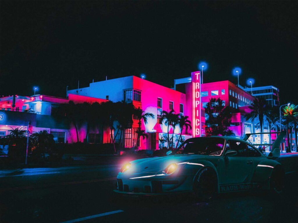 - Artecity Ocean Drive after dark — neon signage and a parked car, South Beach