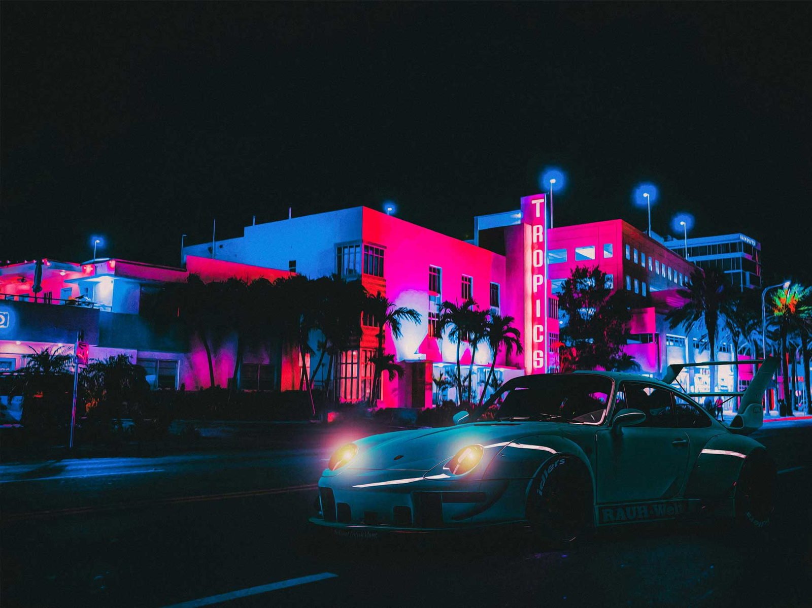 Ocean Drive after dark — neon signage and a parked car, South Beach