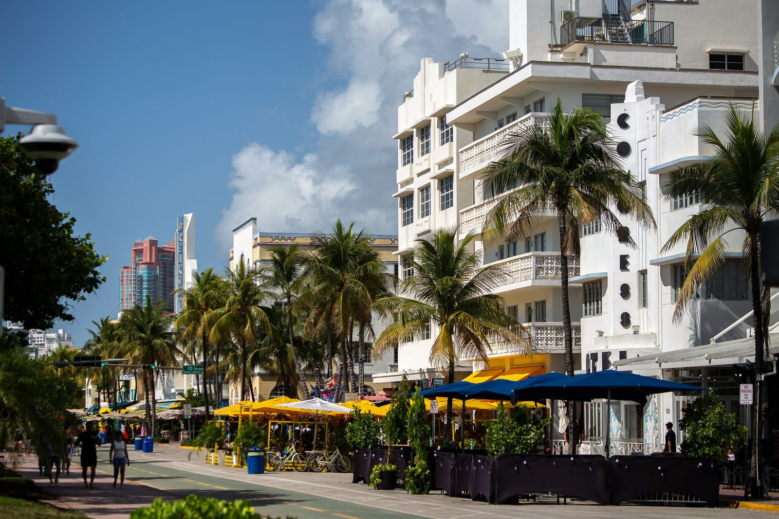 Ocean Drive, South Beach — Art Deco hotels behind yellow café awnings and palms