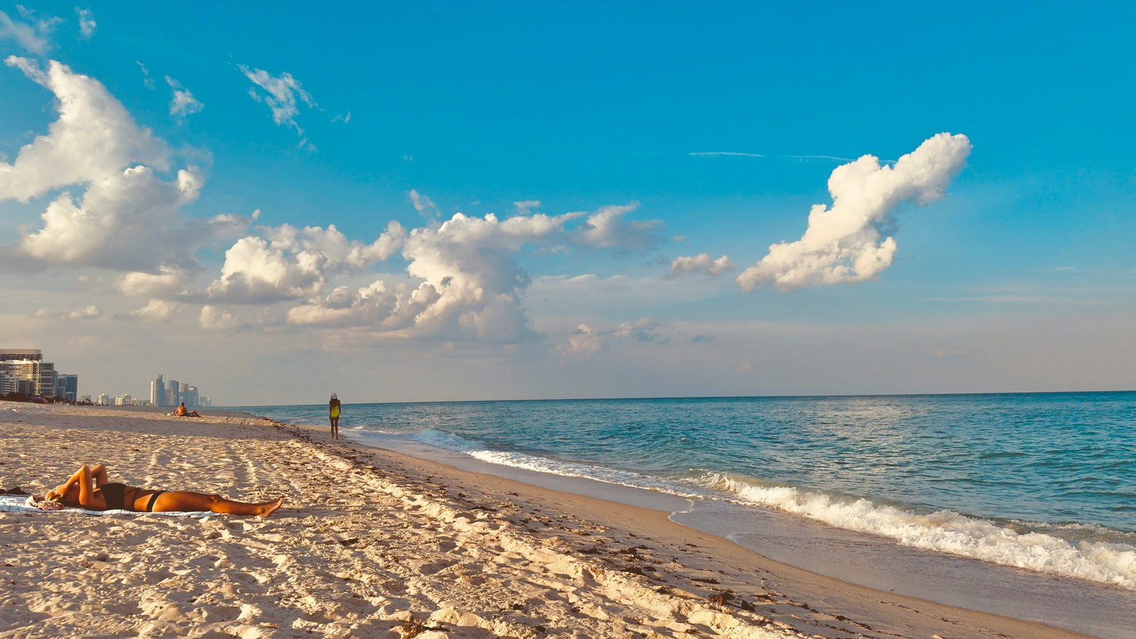 Sunbathers and umbrellas on the sand at South Beach
