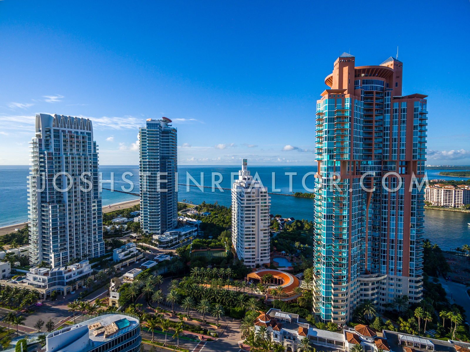 Aerial view of South of Fifth — Portofino Tower, Continuum, Murano Grande and Apogee above South Pointe Park, with Government Cut and Fisher Island beyond