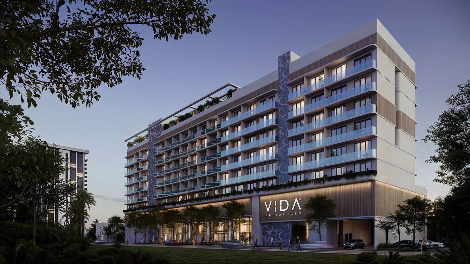 Vida Residences, Edgewater — dusk street-level exterior with illuminated VIDA sign, developer rendering
